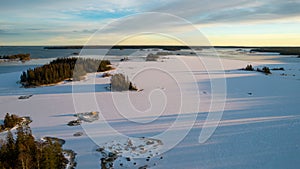 Aerial view of little Swedish village with islands and forests on a Baltic sea coast at winter time. Drone photography - winter in