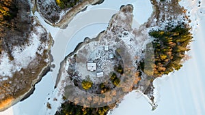 Aerial view of little Swedish village with islands and forests on a Baltic sea coast at winter time. Drone photography - winter in