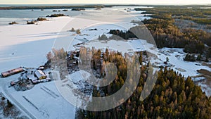 Aerial view of little Swedish village with islands and forests on a Baltic sea coast at winter time. Drone photography - winter in