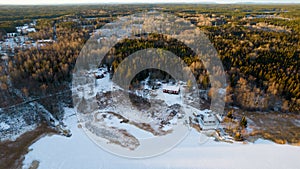 Aerial view of little Swedish village with islands and forests on a Baltic sea coast at winter time. Drone photography - winter in