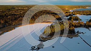 Aerial view of little Swedish village with islands and forests on a Baltic sea coast at winter time. Drone photography - winter in