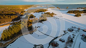 Aerial view of little Swedish village with islands and forests on a Baltic sea coast at winter time. Drone photography - winter in