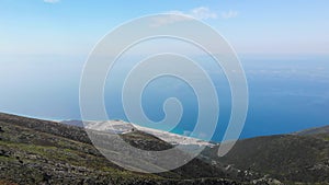 Aerial view from Llogara pass to Albanian Riviera beach, clouds and Ionian Sea coastline