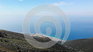 Aerial view from Llogara pass to Albanian Riviera beach, clouds and Ionian Sea coastline