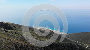 Aerial view from Llogara pass to Albanian Riviera beach, clouds and Ionian Sea coastline