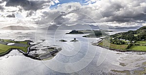 Aerial view of Loch Laich with the historic castle Stalker in the background in Argyll