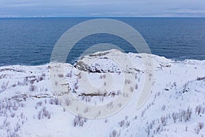 Aerial view of Lofoten islands and lake or river, Nordland county, Norway, Europe. White snowy mountain hills and trees, nature