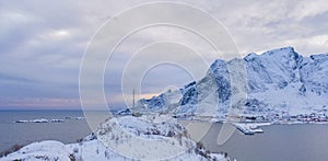 Aerial view of Lofoten islands and lake or river, Nordland county, Norway, Europe. White snowy mountain hills and trees, nature