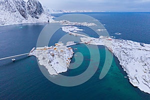 Aerial view of Lofoten islands and lake or river, Nordland county, Norway, Europe. White snowy mountain hills and trees, nature