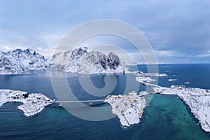 Aerial view of Lofoten islands and lake or river, Nordland county, Norway, Europe. White snowy mountain hills and trees, nature