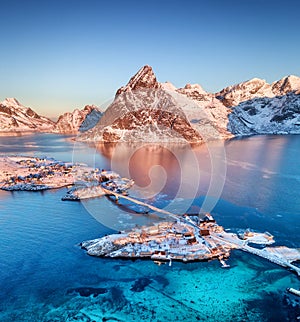 Aerial view at the Lofoten islands, Norway. Mountains and sea during sunset. Natural landscape from air at the drone.