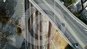 Aerial View of a Lone Cyclist Riding Parallel to a Railway Track During Daytime