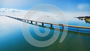 Aerial view of a long highway bridge above a river.