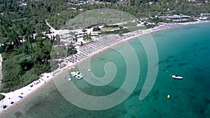 Aerial view of long idyllic turquoise water beach at Pefkohori Halkidiki, Greece, forward and downward movement by drone