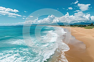 An aerial view of a long sandy beach stretching into the ocean, with waves breaking on the shore