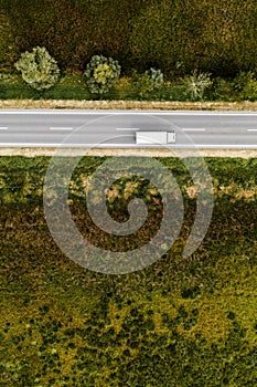 Aerial view of lorry truck on the road through countryside