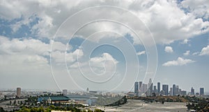 Aerial view of Los Angeles skyline from Elysian Park under blue cloudy sky