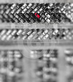 Aerial view lot of vehicles on parking for new car. Black and White selective red colour.