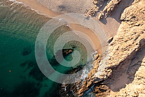 Aerial view of the Lovers Beach sea stacks meeting sea waves photo