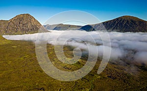 Aerial view of low cloud and fog in a valley just after dawn (Glencoe, Scottish Highlands