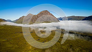 Aerial view of low cloud and fog in a valley just after dawn (Glencoe, Scottish Highlands