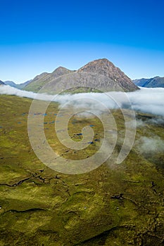 Aerial view of low cloud and fog in a valley just after dawn (Glencoe, Scottish Highlands