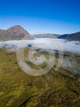 Aerial view of low cloud and fog in a valley just after dawn (Glencoe, Scottish Highlands