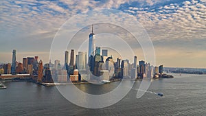 Aerial view of lower Manhattan financial district with modern architecture office buildings shot from helicopter at golden hour