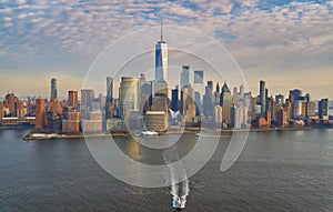 Aerial view of lower Manhattan financial district with modern architecture office buildings shot from helicopter at golden hour