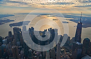 Aerial view of lower Manhattan financial district with modern architecture office buildings shot from helicopter at golden hour