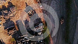 Aerial View of a Lumberyard at Dusk With Forklift Moving Timber