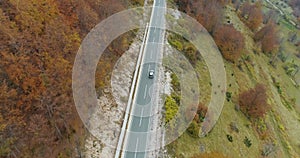 Aerial view of a luxury car driving on country road