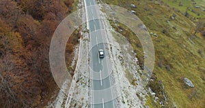 Aerial view of a luxury car driving on country road