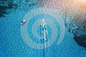 Aerial view of luxury floating boat in transparent blue water