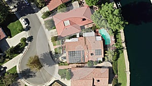 Aerial View of Luxury House With Solar Panel Array on Rooftop by Calabasas Lake