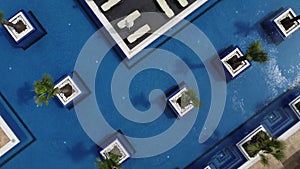 Aerial view of luxury outdoor swimming pool and deck-chairs