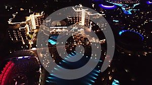 Aerial view on luxury resort hotel territory at night. Video. Night view of illuminated inner territory of hotel complex