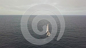 Aerial view luxury sail boat sailing in blue sea on cloudy sky on horizon