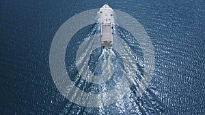 Aerial view of luxury tourist speed boat cruising in blue sea water.