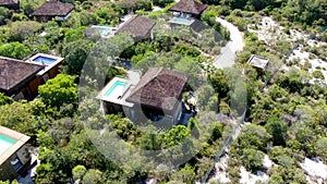 Aerial view of luxury villa with swimming pool in tropical forest.