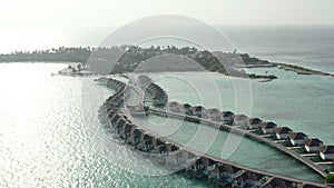 Aerial view of luxury villas over water on blue lagoon