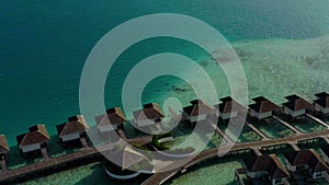 Aerial view of luxury villas over water on blue lagoon