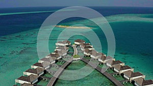 Aerial view of luxury villas over water on blue lagoon