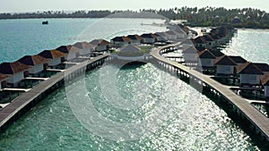 Aerial view of luxury villas over water on blue lagoon