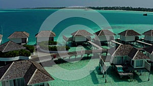 Aerial view of luxury villas over water on blue lagoon