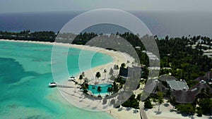 Aerial view of luxury villas over water on blue lagoon