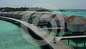 Aerial view of luxury villas over water on blue lagoon