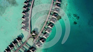 Aerial view of luxury villas over water on blue lagoon