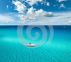 Aerial view of luxury yacht and boat in blue sea in summer day