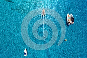 Aerial view of luxury yachts in transparent blue sea
